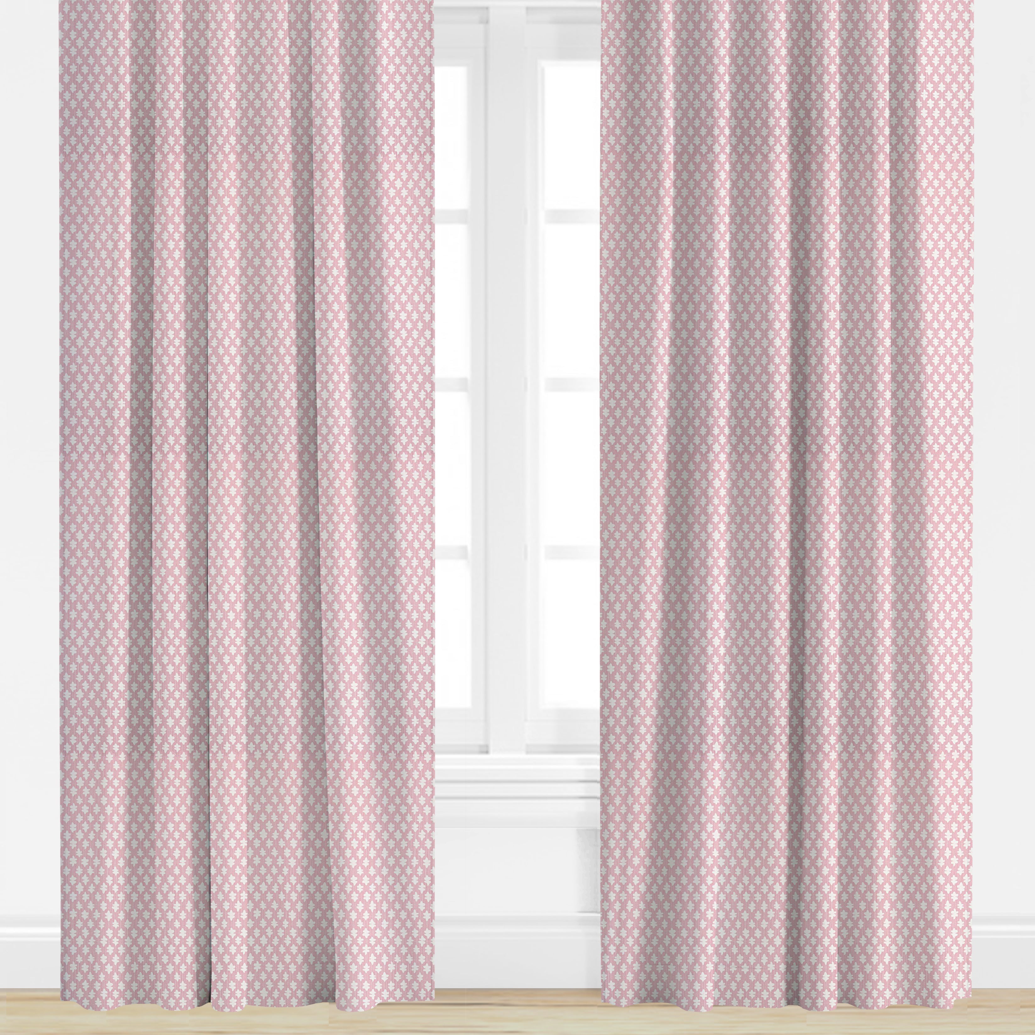 Pink curtains with a subtle pattern in front of a window.