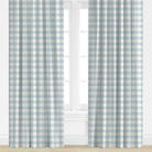 Checkered drapes in blue and white with a window in the background
