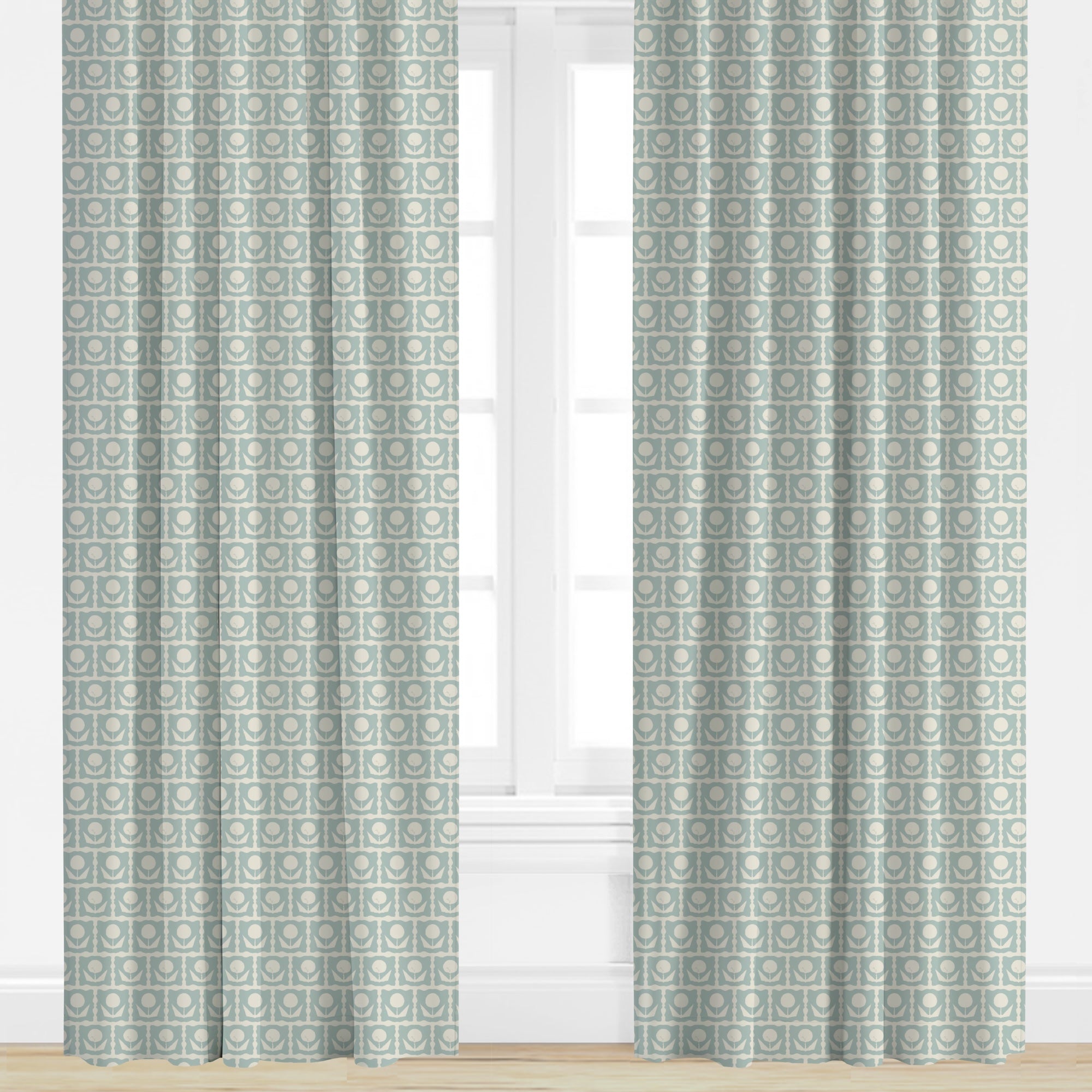Floral patterned curtains in blue on a window with a neutral background
