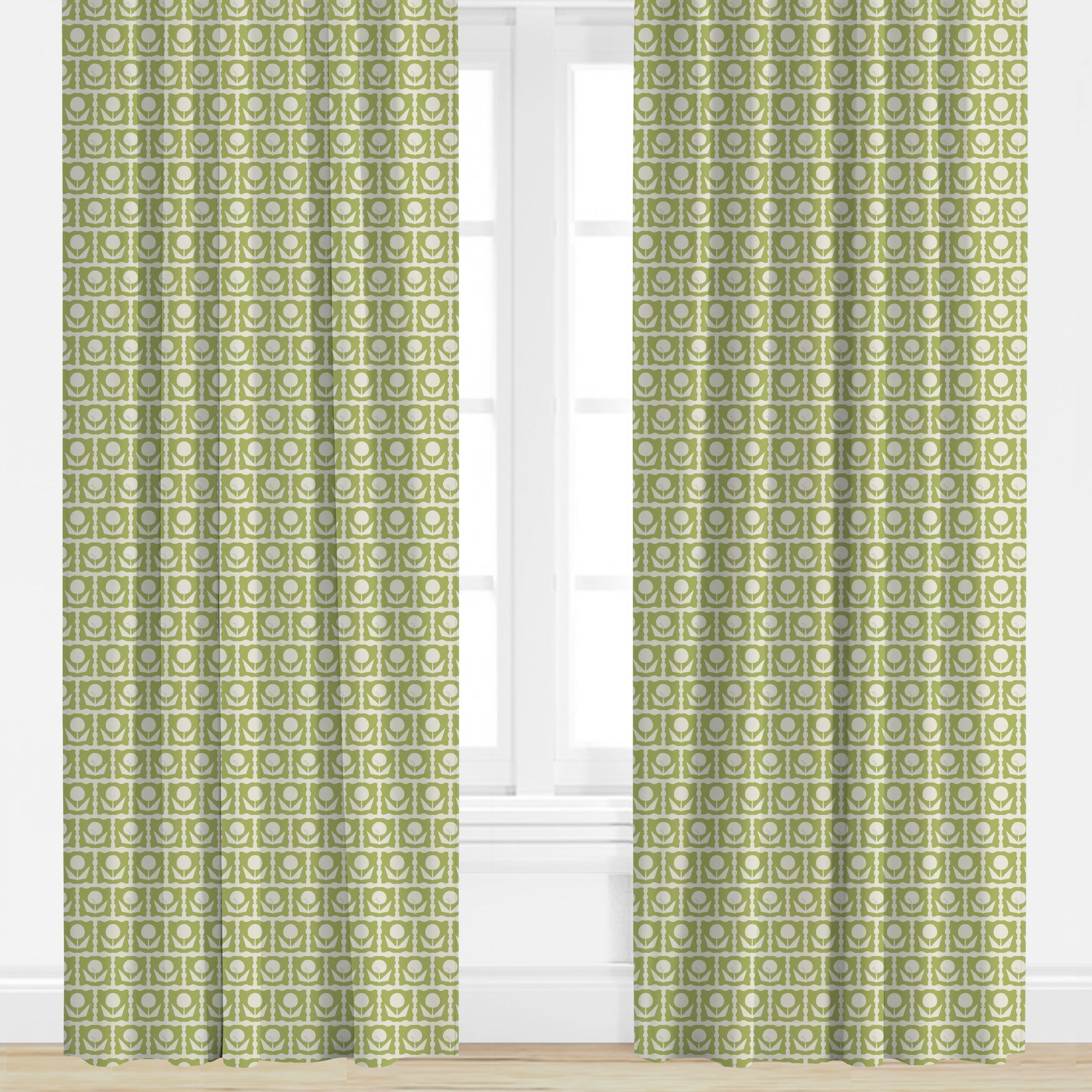 Green floral patterned curtains on a white window with a wooden floor.