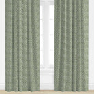 Green and blue floral patterned curtains on a white window background