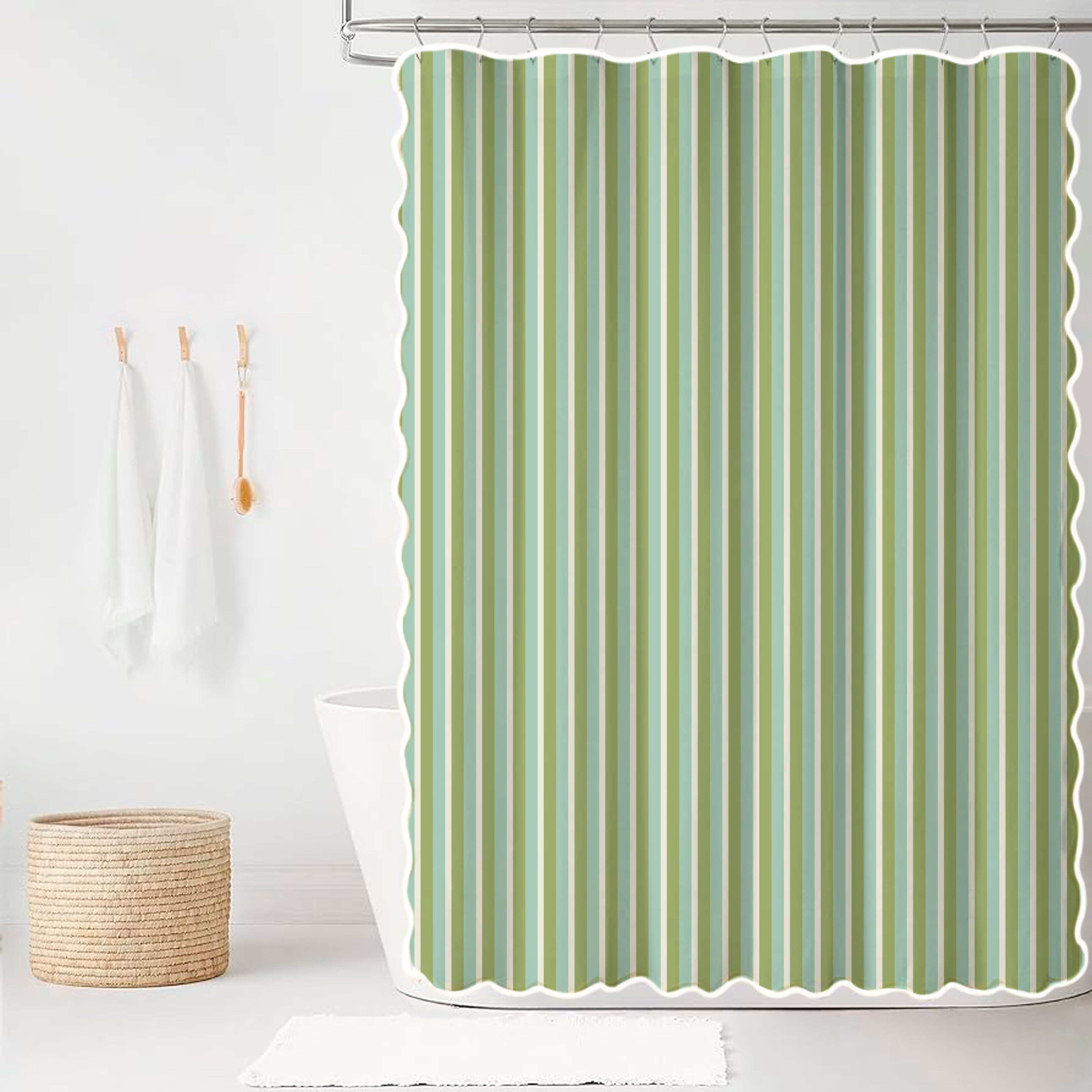 Green striped shower curtain with scalloped edge in a bathroom setting.