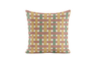 Decorative pillow with a geometric red, green and yellow pattern on a white background