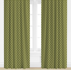 Green, star patterned curtains on a white window background