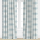 Blue Patterned curtains on a window with a light background