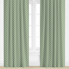 Green leaf patterned curtains on a window with a white background
