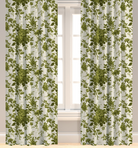 A set of green leaf patterned drapery panels hanging on a window, with a visible pleated design and lining.
